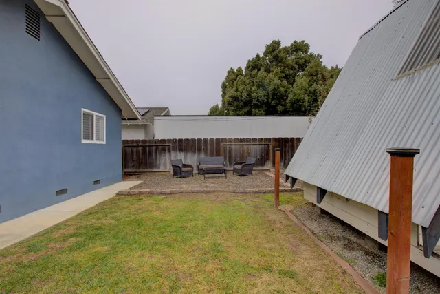 a view of house with swimming pool and sitting area