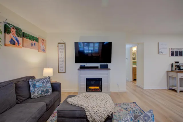 a living room with furniture flat screen tv and a fireplace