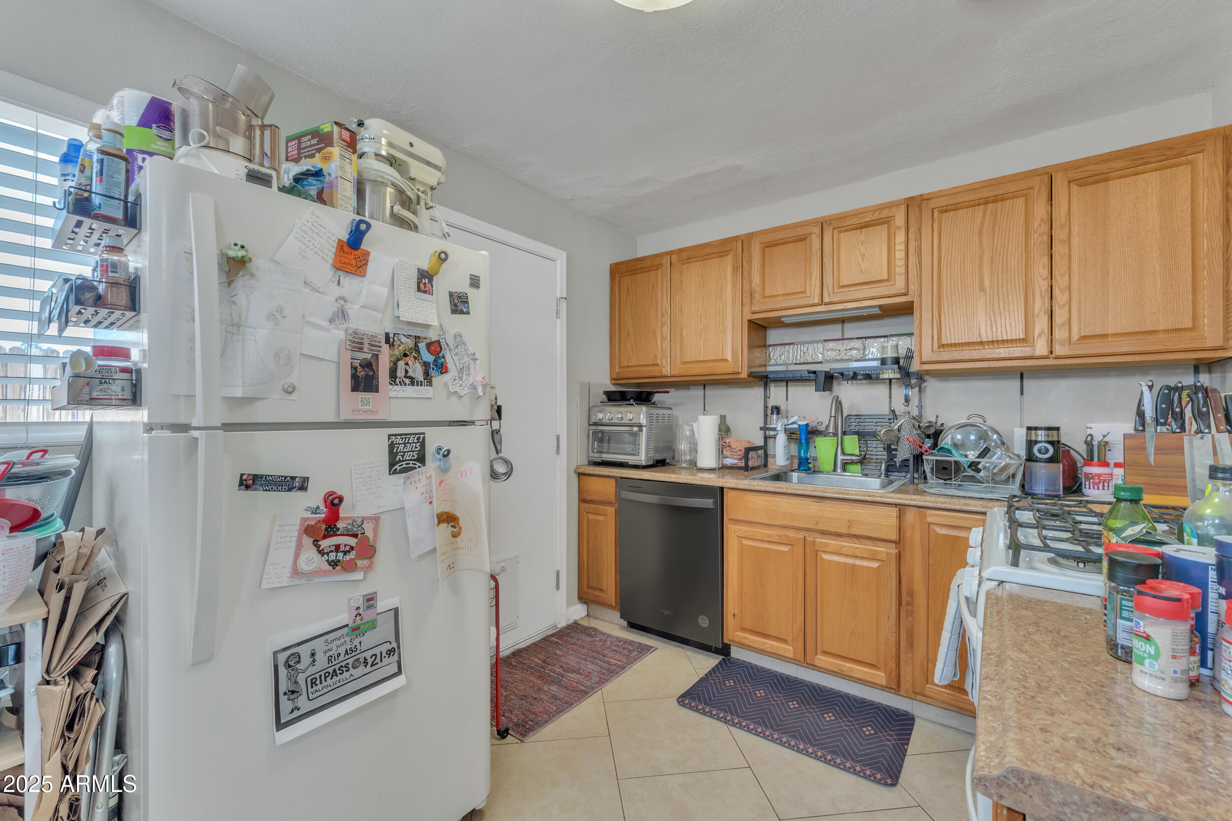 1024 East Mitchell Drive Phoenix, AZ 85014 - Photo 18 of 44 a kitchen with a refrigerator and cabinets