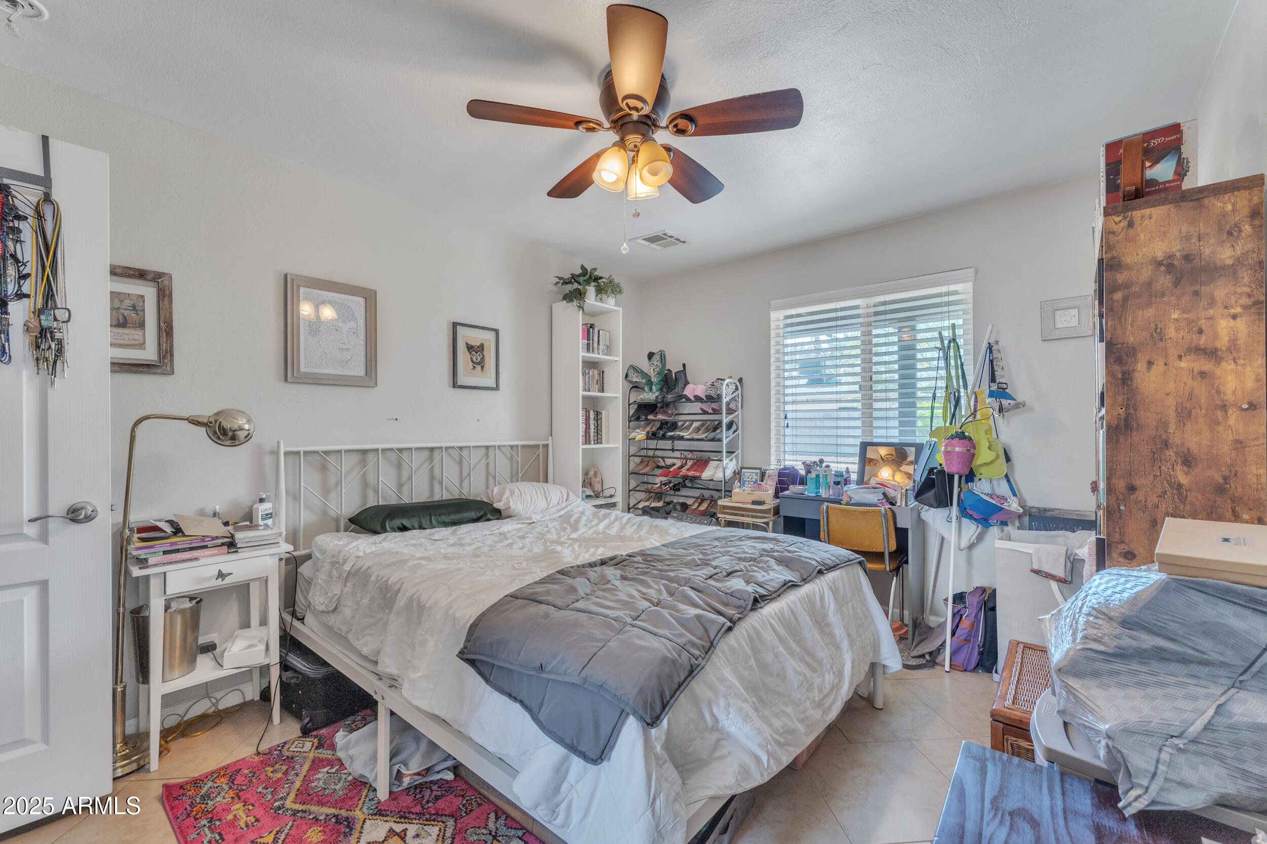 1024 East Mitchell Drive Phoenix, AZ 85014 - Photo 20 of 44 a bedroom with a bed and a chandelier