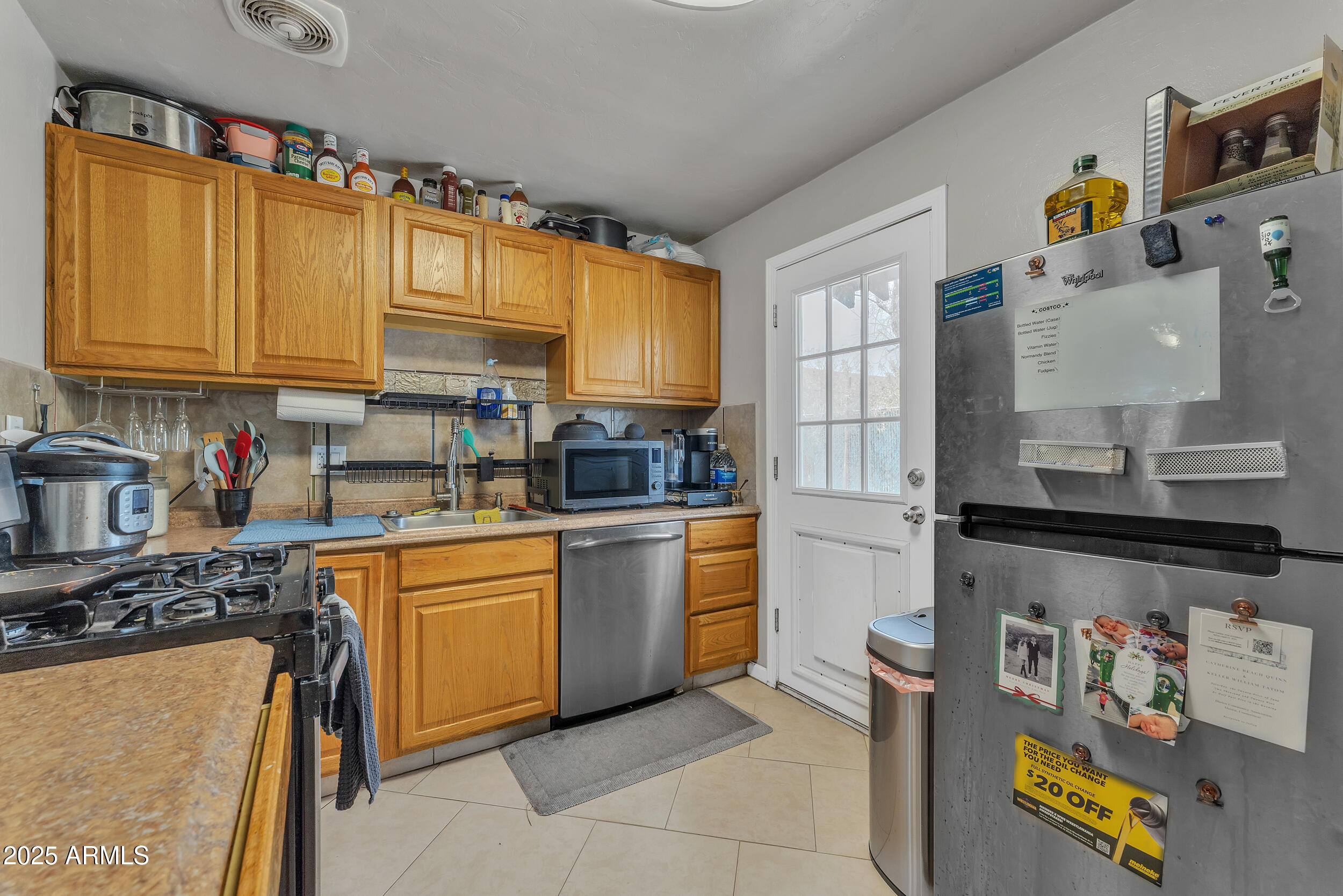 1024 East Mitchell Drive Phoenix, AZ 85014 - Photo 28 of 44 a kitchen with stainless steel appliances granite countertop a sink a stove and a refrigerator