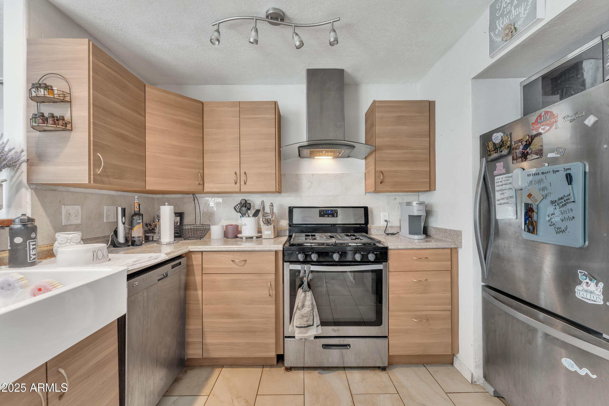 1024 East Mitchell Drive Phoenix, AZ 85014 - Photo 10 of 44 a kitchen with stainless steel appliances a stove a sink and cabinets