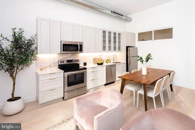 a kitchen with a table and chairs