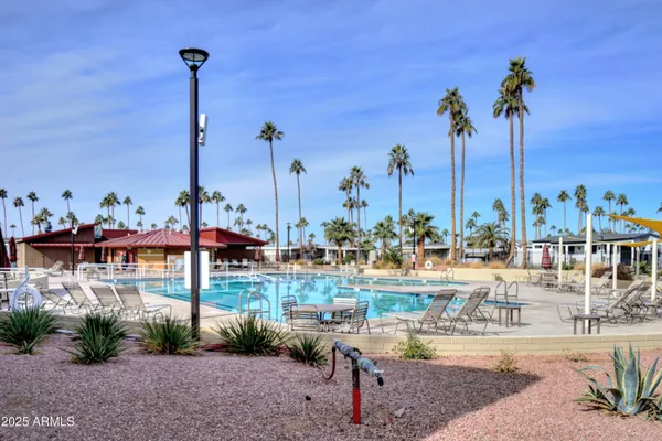a view of a swimming pool with lounge chairs