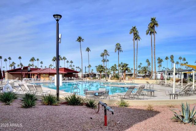 a view of a swimming pool with lounge chairs