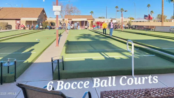 a view of a tall building with a palm tree in the background