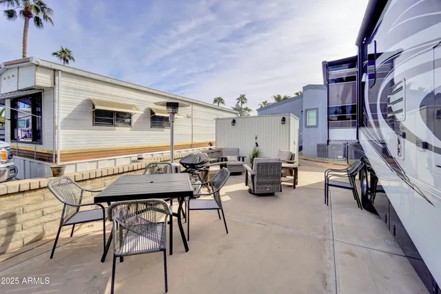 a backyard of a house with table and chairs