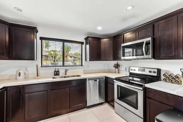 a kitchen with a sink stove and microwave