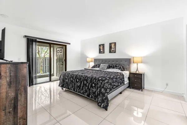 a bedroom with a large bed and a tv