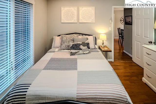 a bed sitting in a bedroom next to a window