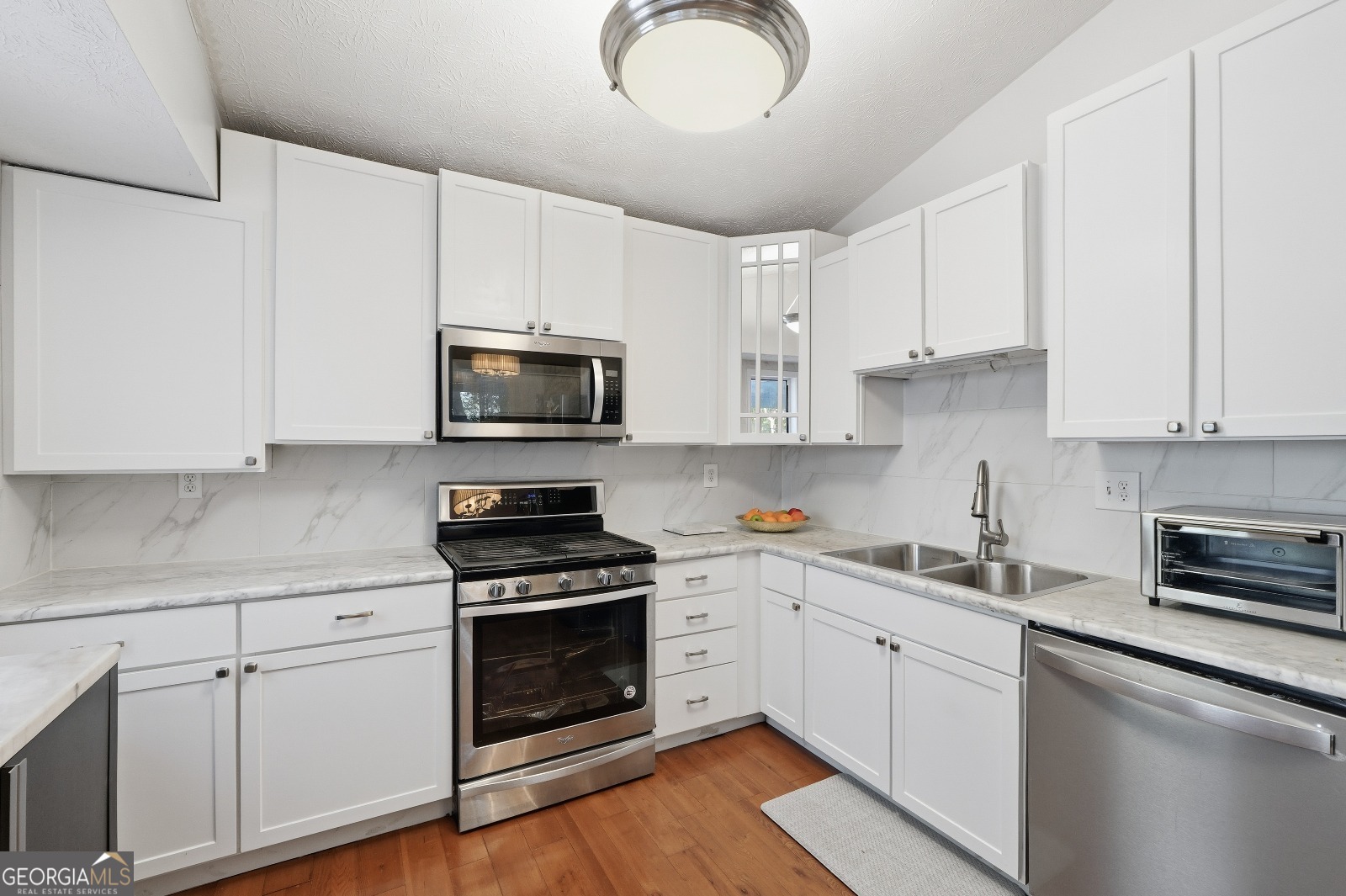 5421 Burdette Road Southeast Mableton, GA 30126 - Photo 18 of 64 a kitchen with cabinets stainless steel appliances and wooden floor