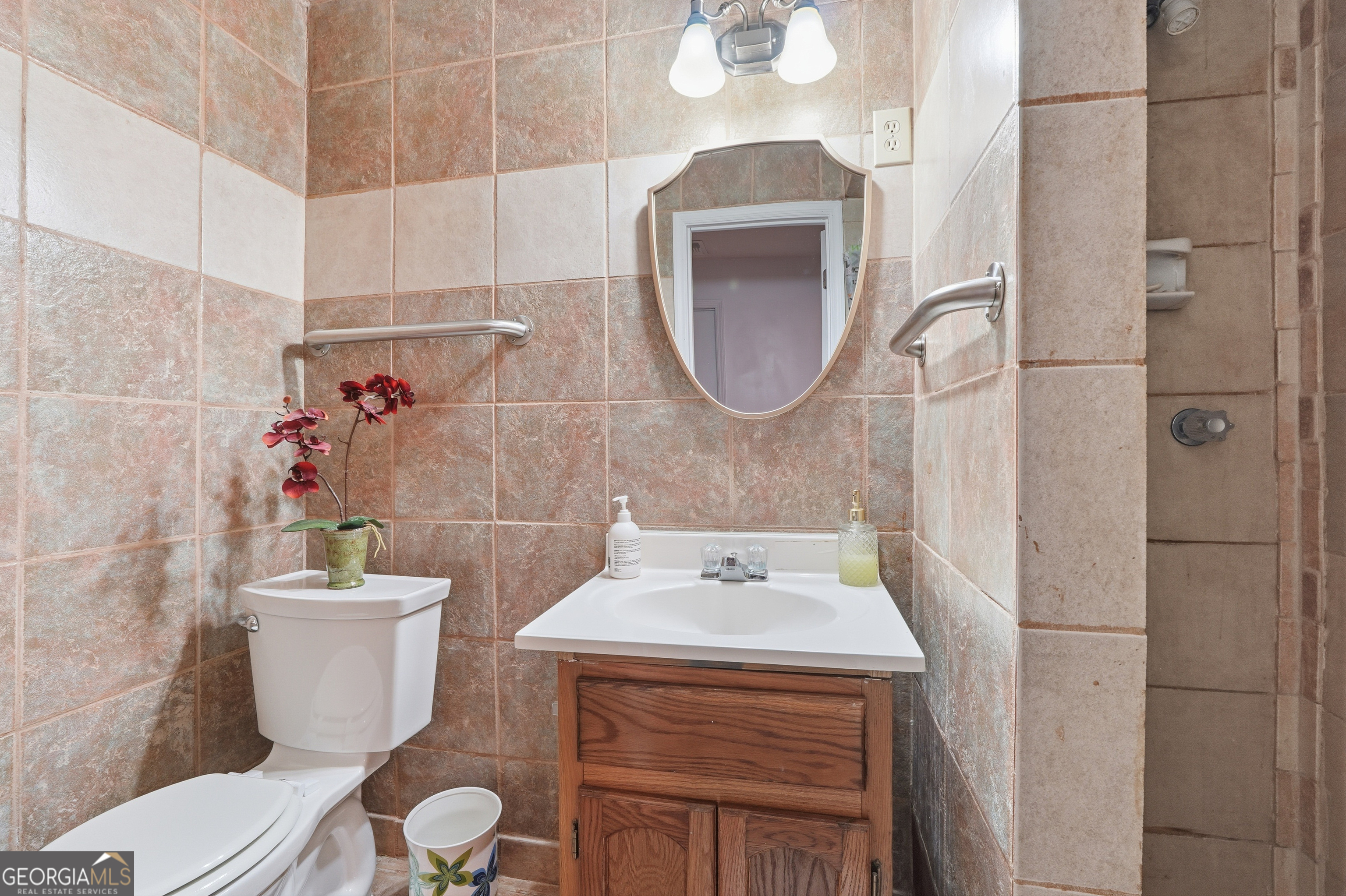 5421 Burdette Road Southeast Mableton, GA 30126 - Photo 42 of 64 a bathroom with a sink toilet and a mirror