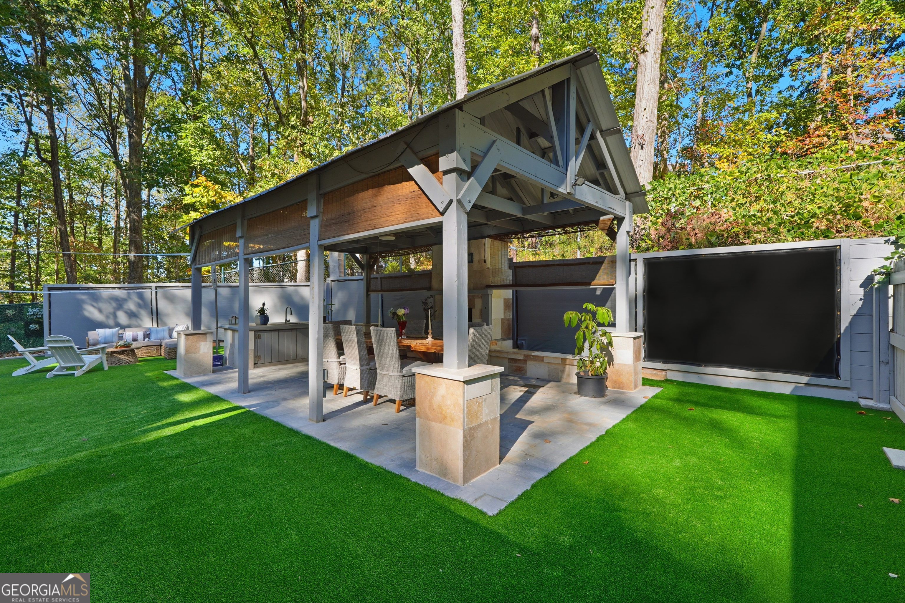 5421 Burdette Road Southeast Mableton, GA 30126 - Photo 49 of 64 a view of a patio with table and chairs potted plants and large tree