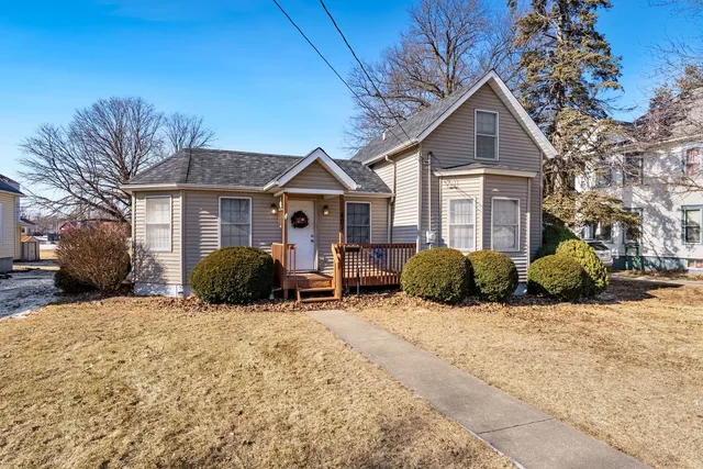 a view of a house with a yard covered in snow