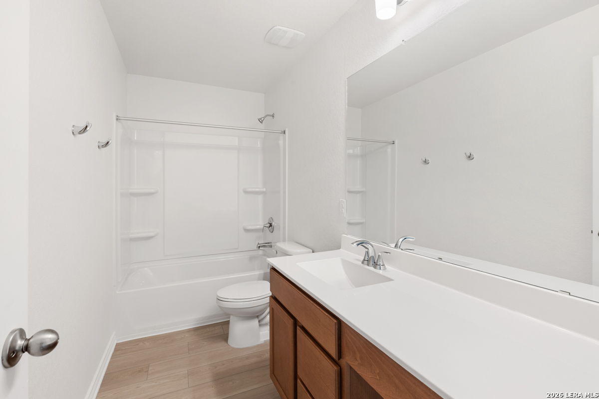 10045 Jagger Avenue Converse, TX 78109 - Photo 24 of 28 a bathroom with a sink a toilet and shower