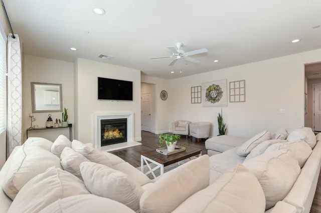 a living room with furniture fireplace and a flat screen tv