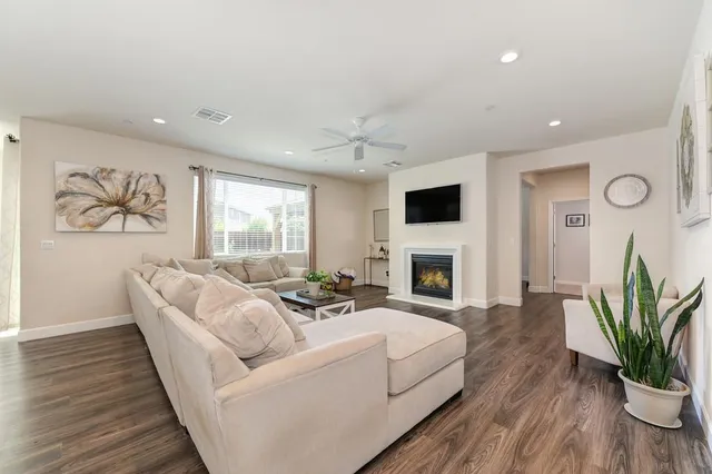 a living room with furniture fireplace and flat screen tv