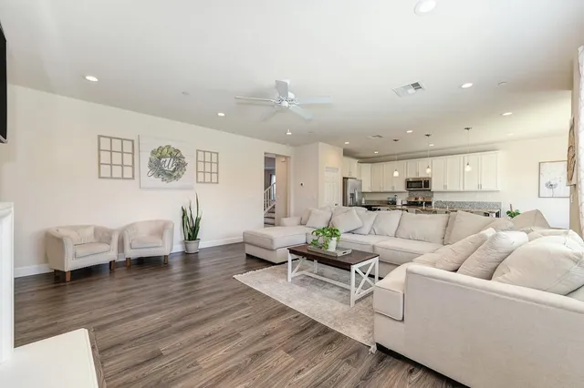 a living room with furniture or couch and a view of kitchen