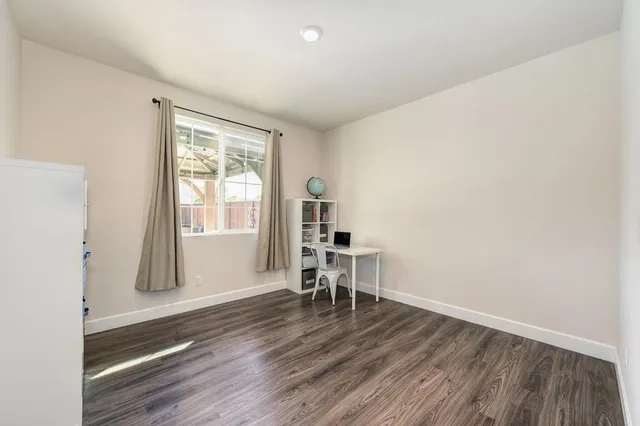 a room with wooden floor and a window