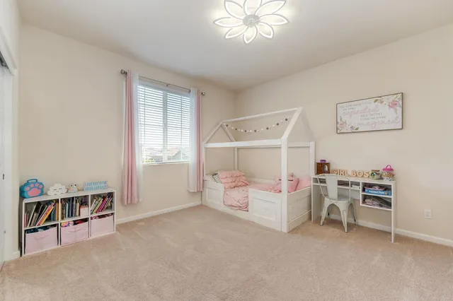 a bedroom with furniture and a chandelier fan