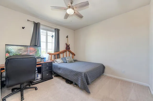 a bedroom with a bed and window