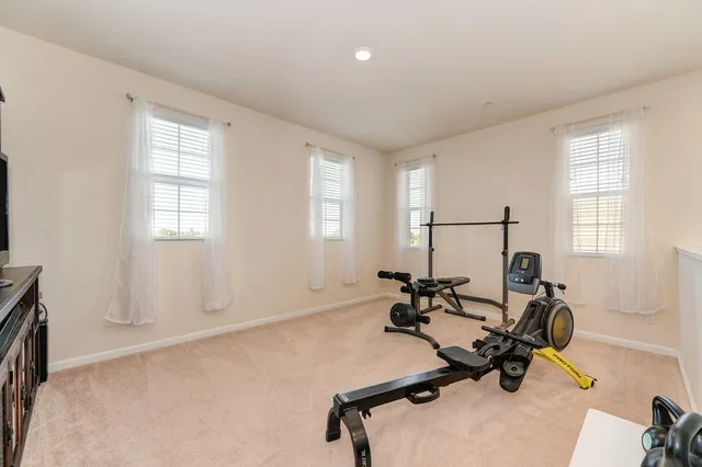 a room with gym equipment and windows