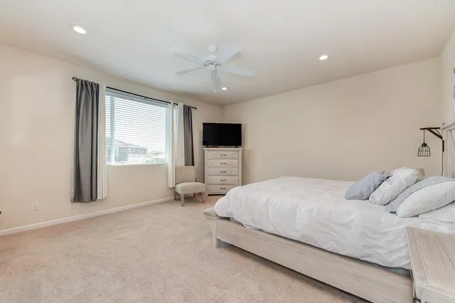 a bedroom with a large bed and a flat screen tv