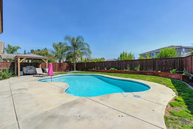 a view of swimming pool with sitting area and slide