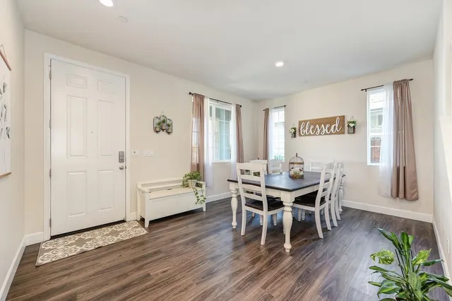 a dining room with furniture and wooden floor