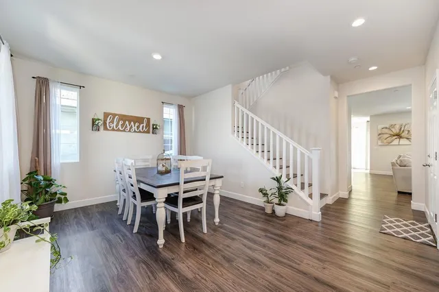 a view of a dining room with furniture and wooden floor