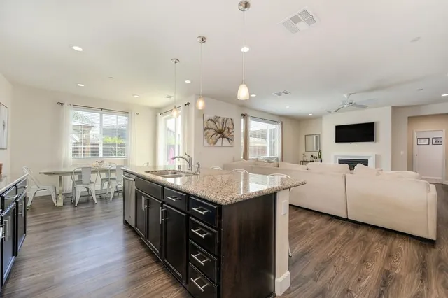a kitchen with counter top space sink and center island