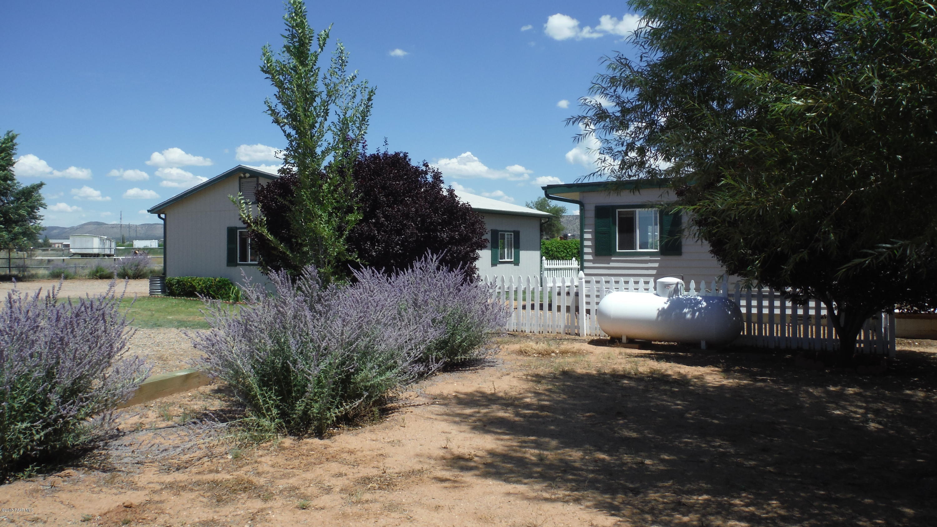 25356 North High Desert Road Paulden, AZ 86334 - Photo 18 of 56 a front view of a house with a yard and garage