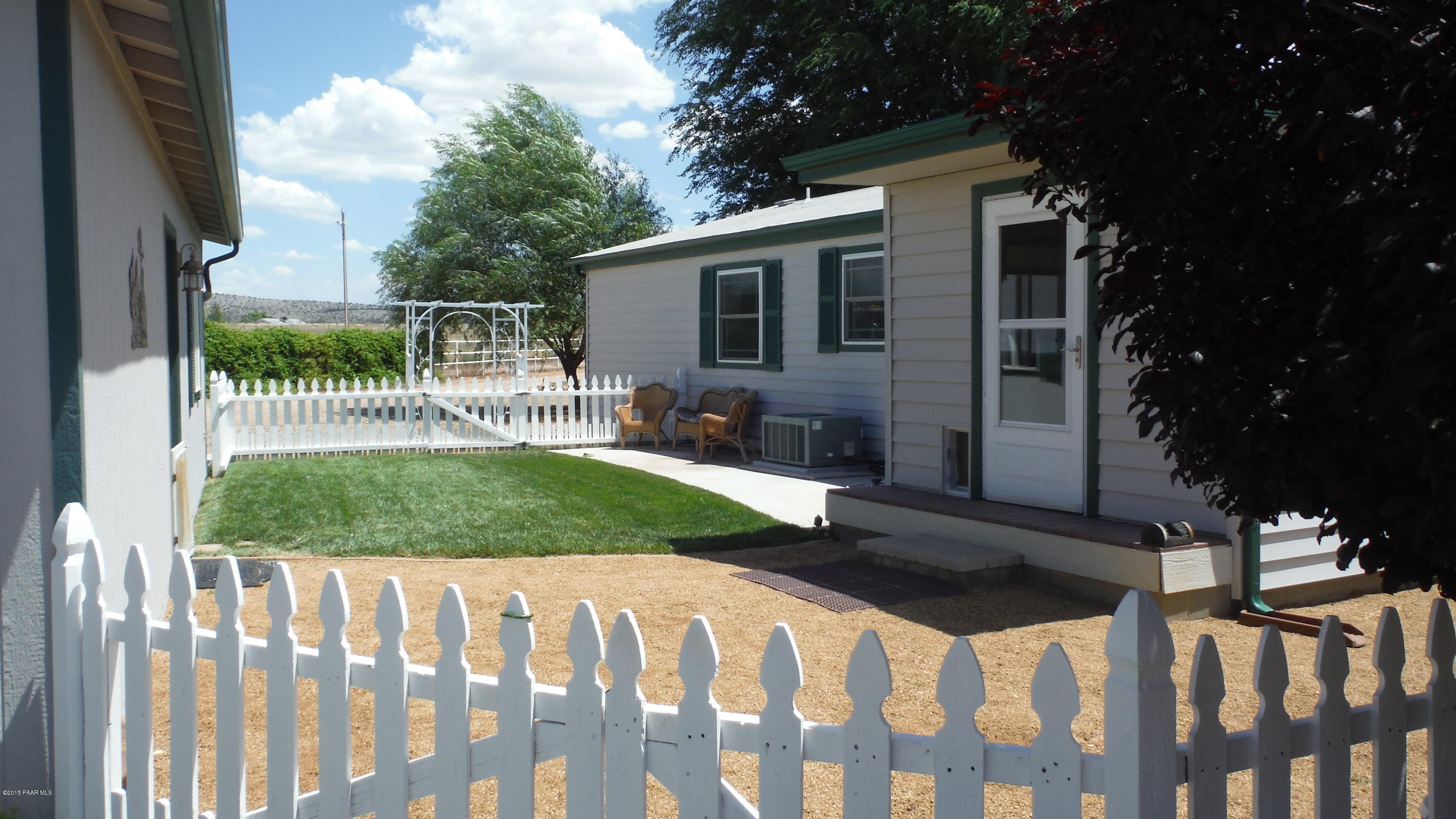 25356 North High Desert Road Paulden, AZ 86334 - Photo 3 of 56 a front view of a house with a yard table and chairs