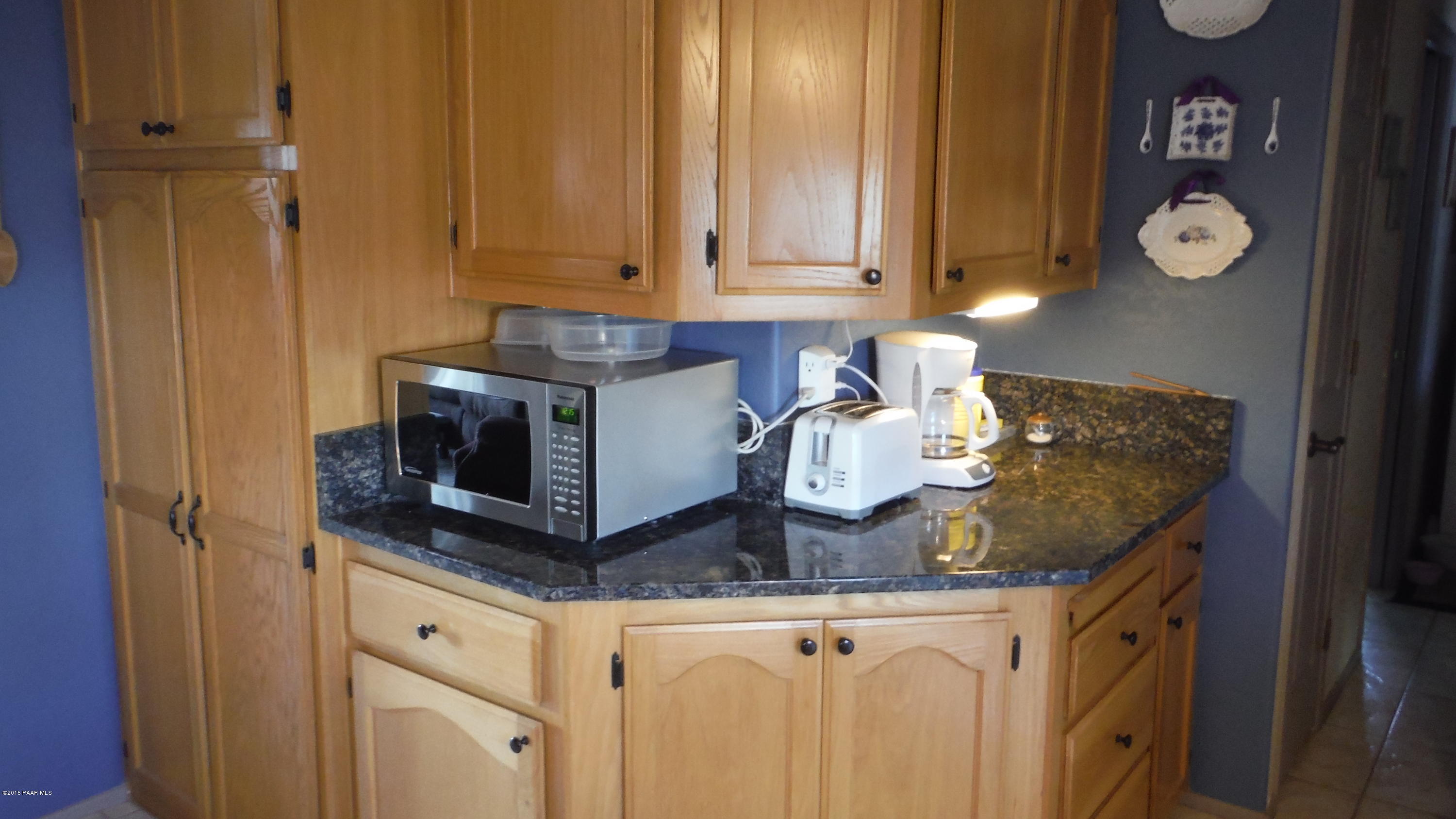 25356 North High Desert Road Paulden, AZ 86334 - Photo 43 of 56 a kitchen with stainless steel appliances granite countertop a sink and cabinets