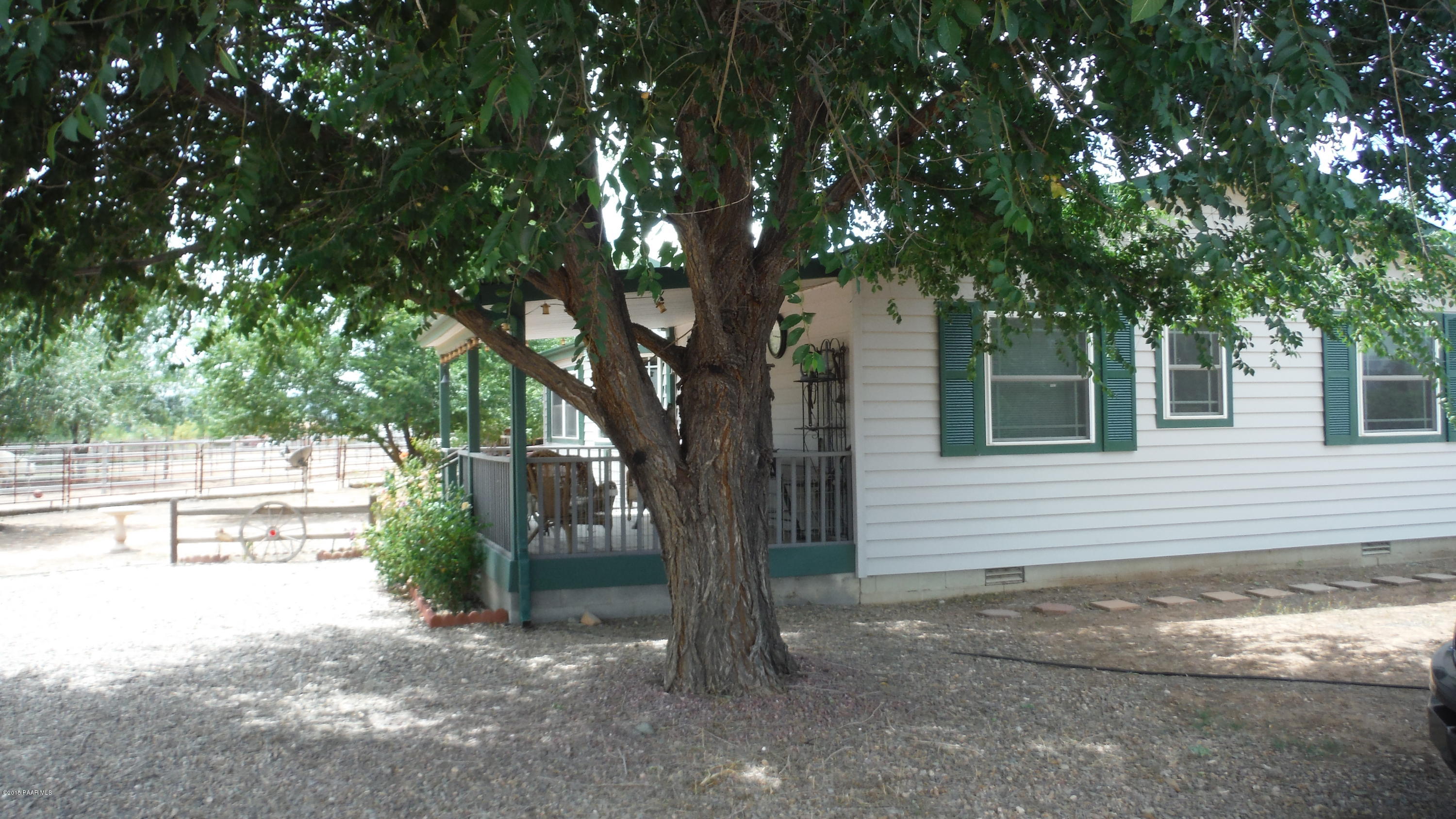 25356 North High Desert Road Paulden, AZ 86334 - Photo 50 of 56 a tree in a yard next to a building