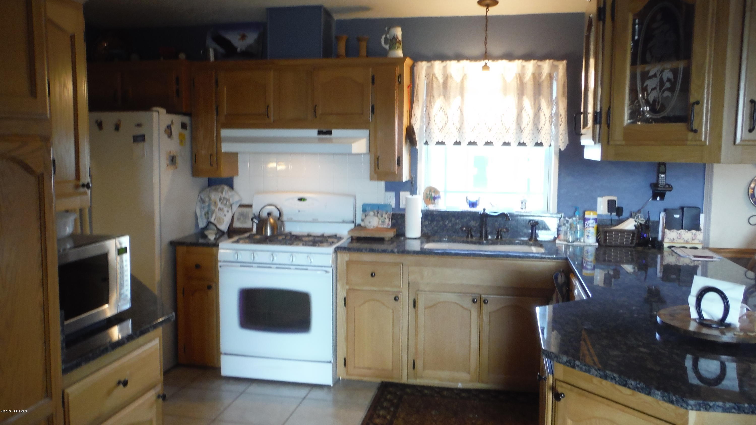 25356 North High Desert Road Paulden, AZ 86334 - Photo 6 of 56 a kitchen with a sink stove and refrigerator