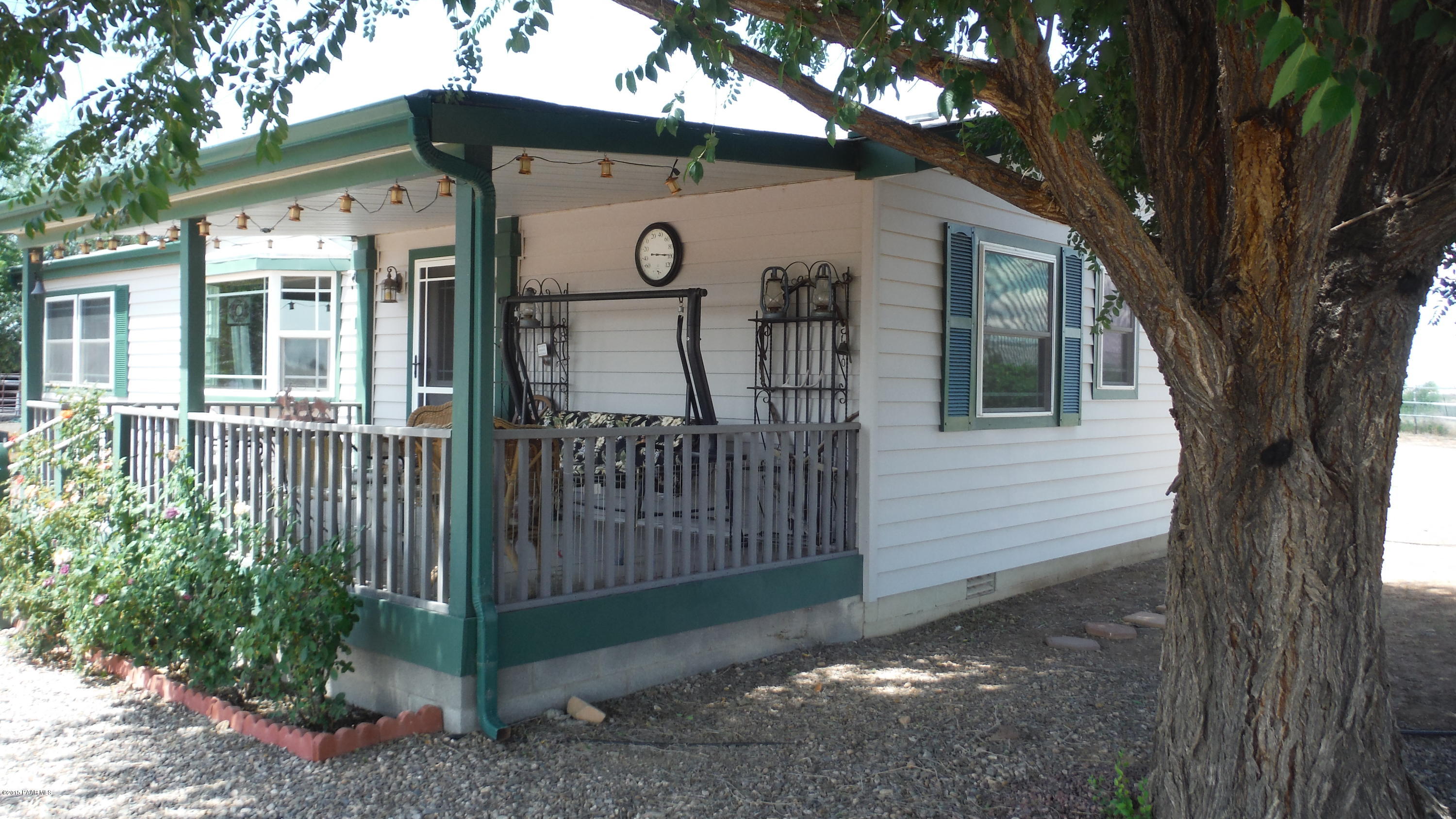 25356 North High Desert Road Paulden, AZ 86334 - Photo 9 of 56 a view of a house with a small yard and a large tree