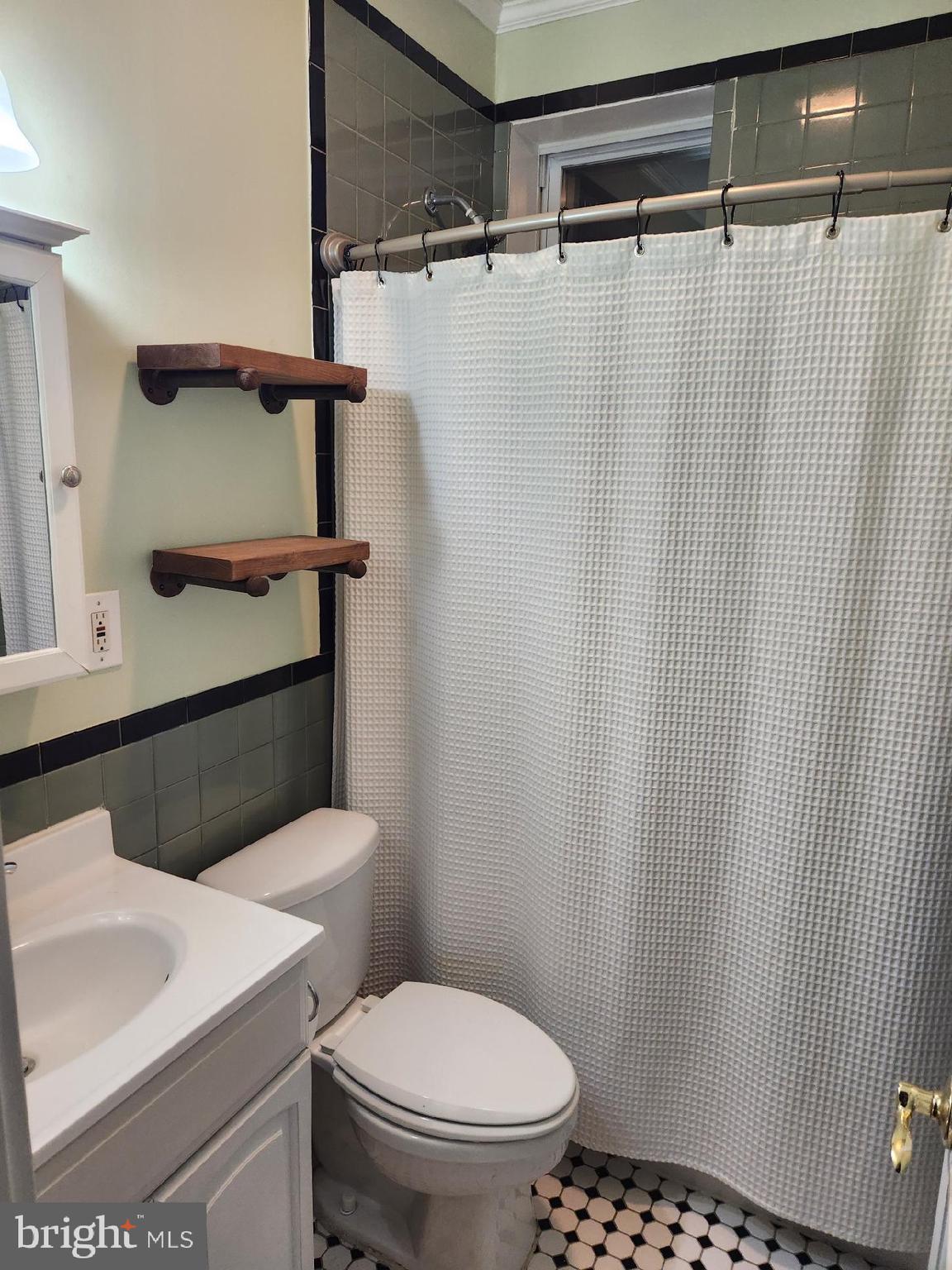 701 Grundy Street Baltimore, MD 21224 - Photo 11 of 22 a bathroom with a shower curtain