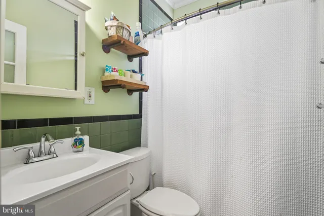 a bathroom with a sink a toilet and mirror