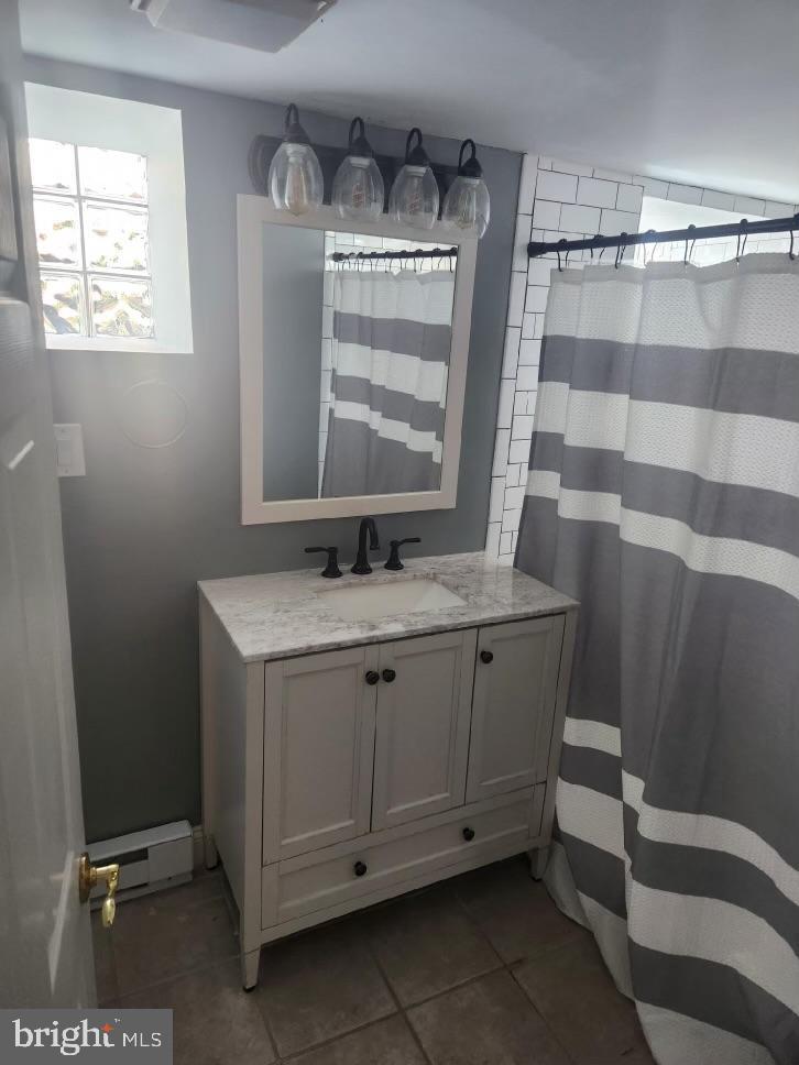 701 Grundy Street Baltimore, MD 21224 - Photo 19 of 22 a bathroom with a granite countertop sink toilet and shower