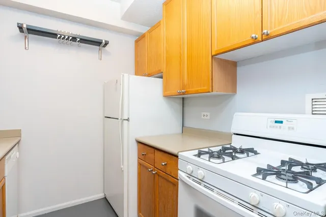 a kitchen with a refrigerator and a stove