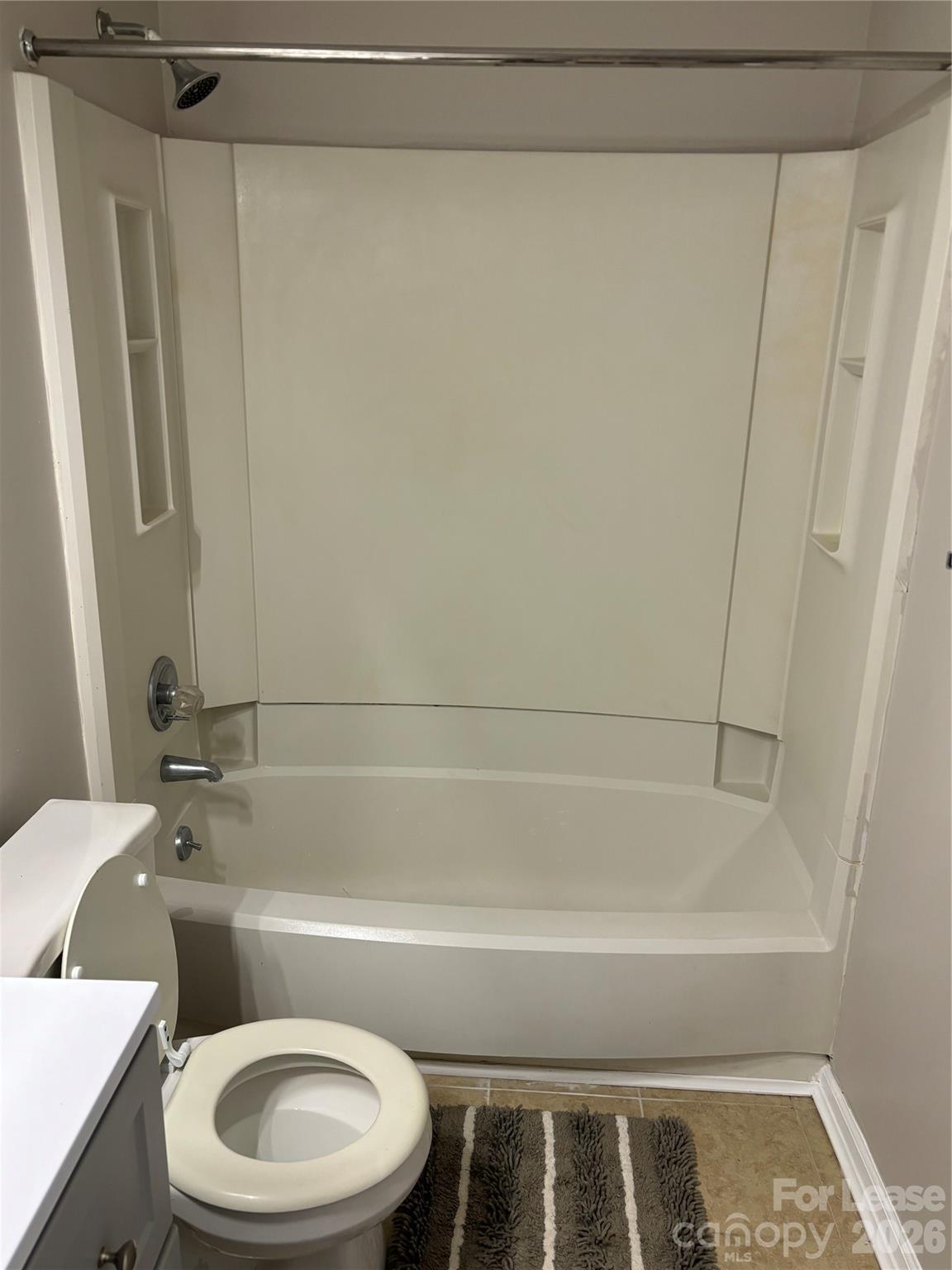 11040 Harrowfield Road Charlotte, NC 28226 - Photo 12 of 14 a bathroom with a toilet and a bathtub