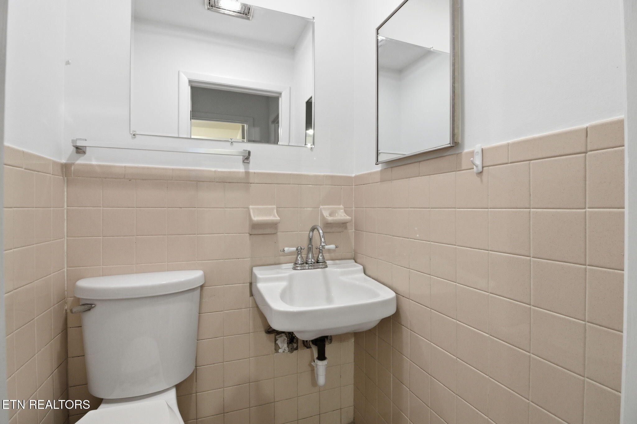 353 East Wolf Valley Road Heiskell, TN 37754 - Photo 18 of 34 a bathroom with a sink a toilet and mirror