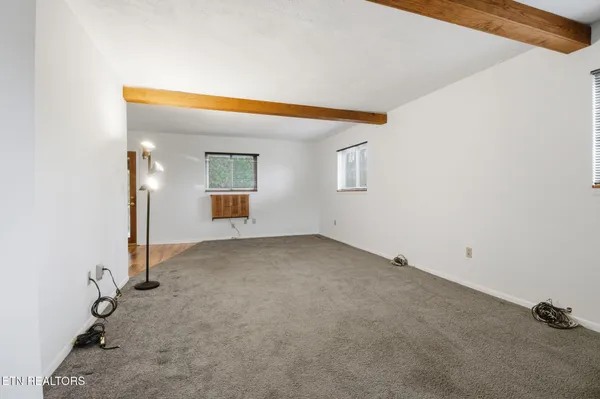 a view of a livingroom with wooden floor and cabinet