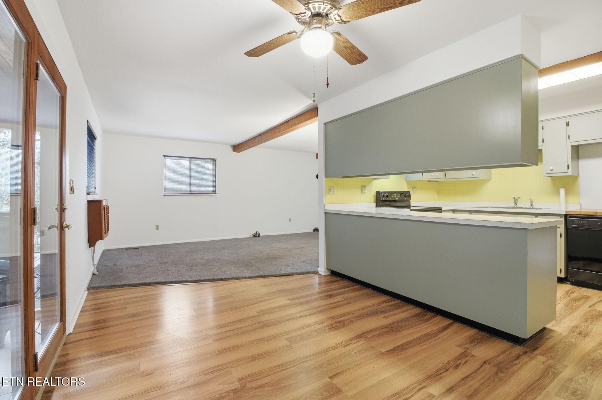 353 East Wolf Valley Road Heiskell, TN 37754 - Photo 6 of 34 a view of a kitchen with a fridge and wooden floor