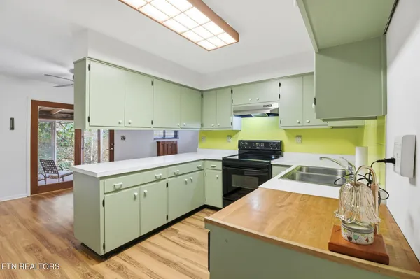 a view of a livingroom with furniture and kitchen view