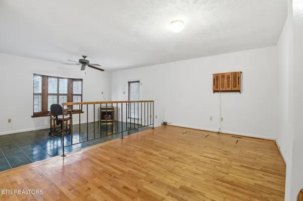 a view of a room with wooden floor