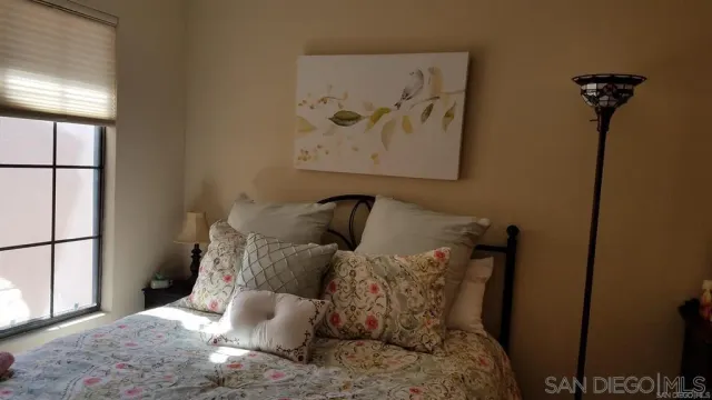 a large bed sitting in a bedroom next to a window