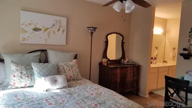 a bedroom with bed and wooden floor