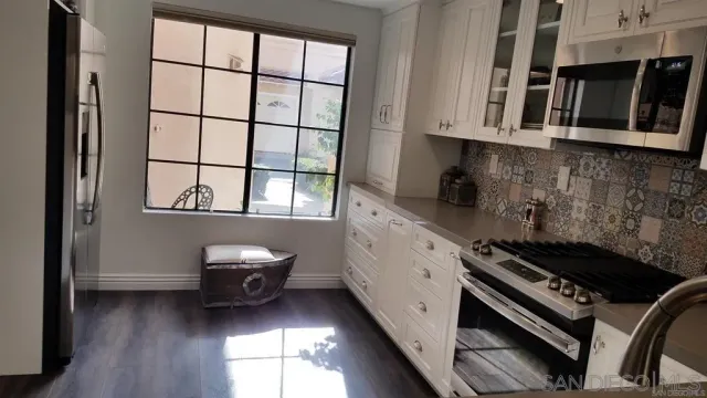 a kitchen with stainless steel appliances a stove a microwave and cabinets